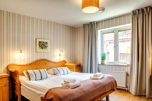 1 dormitorio con 1 cama con toallas en Hotell Gute, en Visby