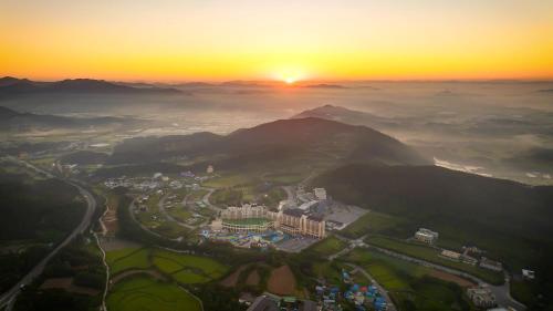 an aerial view of a city with the sunset in the background at Sono Belle Cheonan in Cheonan
