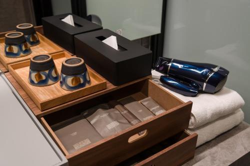a wooden drawer with a box of wine bottles at D-and Stay 5 Resort Okinawa in Urasoe