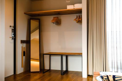 a dressing room with a table and a mirror at D-and Stay 5 Resort Okinawa in Urasoe