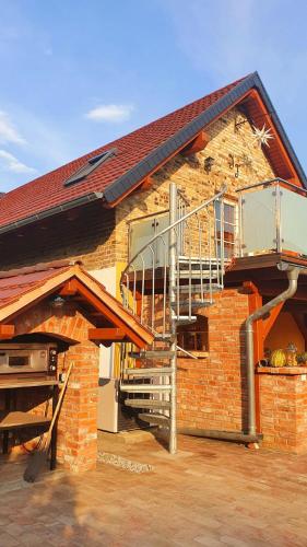 a brick house with a staircase and a balcony at Urlaubshof Turmblick in Kreba