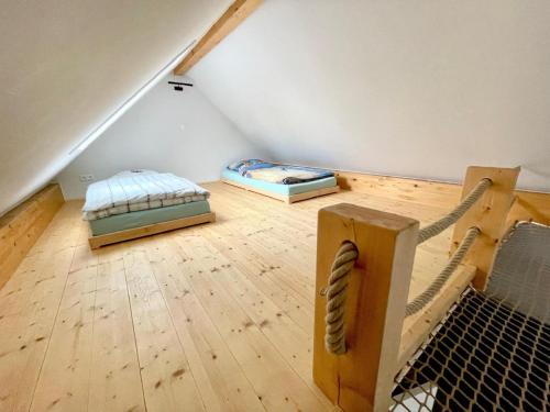 a attic room with two beds and a baseball bat at Urlaubshof Turmblick in Kreba