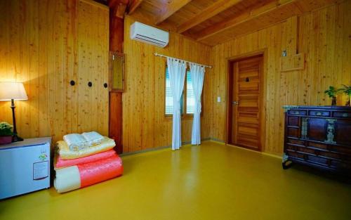a living room with wooden walls and a room with a table at Full of Love Guesthouse in Jeonju