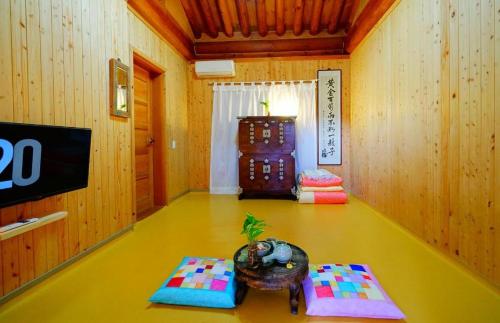 a living room with a table and a tv at Full of Love Guesthouse in Jeonju