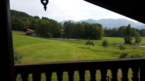 a view of a green field from a window at Maria Schnitzenbaumer in Fischbachau