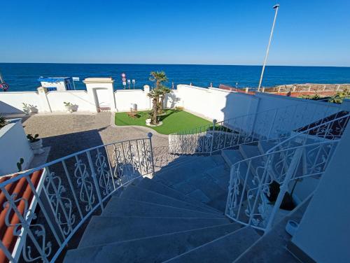 a staircase leading down to the ocean from a building at Ventidue Venti in Bari