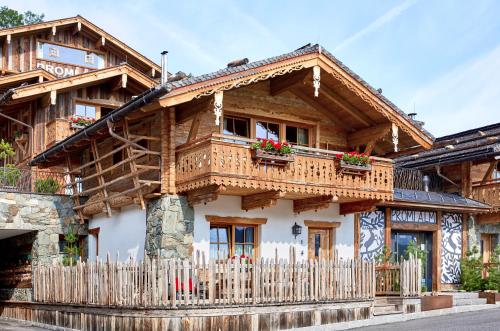 a wooden house with a fence in front of it at Promi Alm Flachau - Luxus Chalets in Flachau