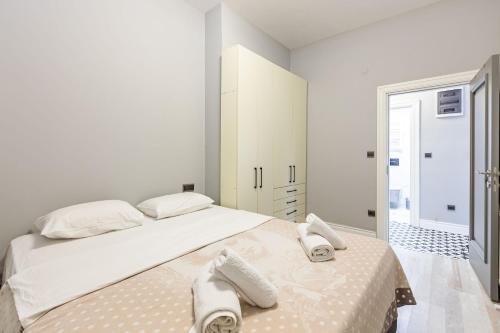 a white bedroom with a large bed with towels on it at Cozy Flat with Central Location in Moda Kadikoy in Istanbul