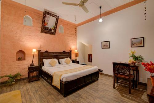 a bedroom with a large bed in a room at Fort Dadhikar, Alwar in Alwar