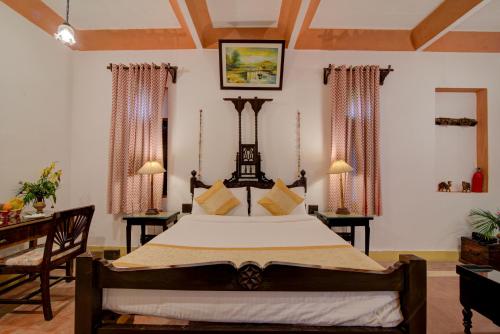 a bedroom with a large bed in a room at Fort Dadhikar, Alwar in Alwar
