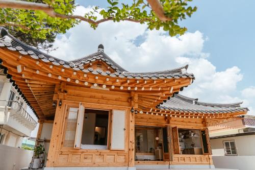 a wooden building with a chinese roof at Gyeongju Hanok Sohwa in Gyeongju