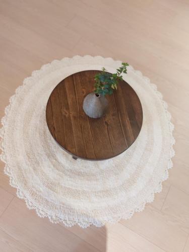a wooden table with a plant on top of it at Gyeongju Hanok Sohwa in Gyeongju
