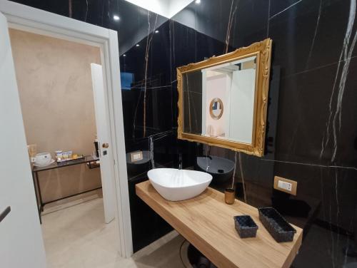 a bathroom with a sink and a mirror at Ventidue Venti in Bari