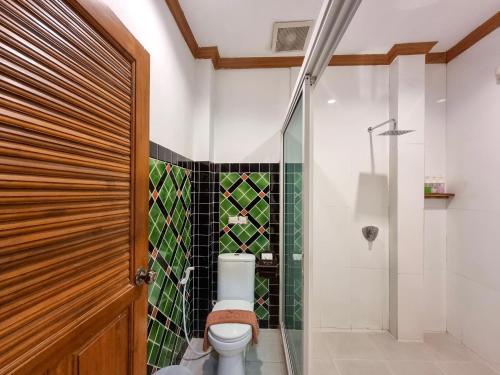 a bathroom with a toilet and a glass shower at Phuvara Boutique Aonang in Ao Nang Beach