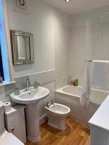 a bathroom with a sink and a toilet and a tub at The Old Pie Shop Hebden Bridge in Hebden Bridge