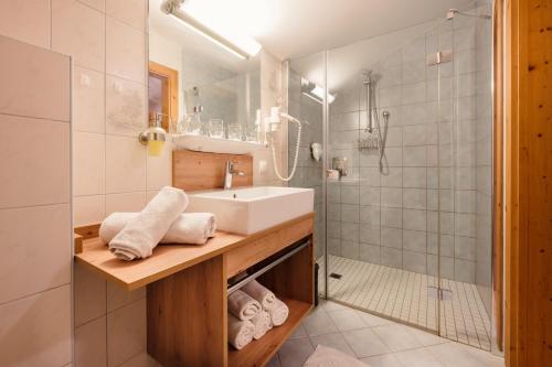 a bathroom with a sink and a shower at Familienbauernhof Samerhof in Pfarrwerfen