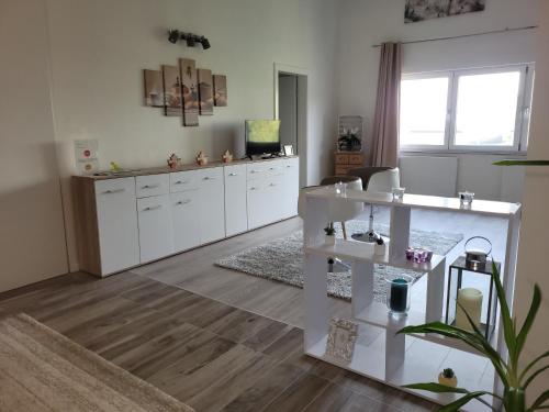 a living room with white cabinets and a table at Penthouse N74 Linz 120 QM KIDS WELCOME! in Linz