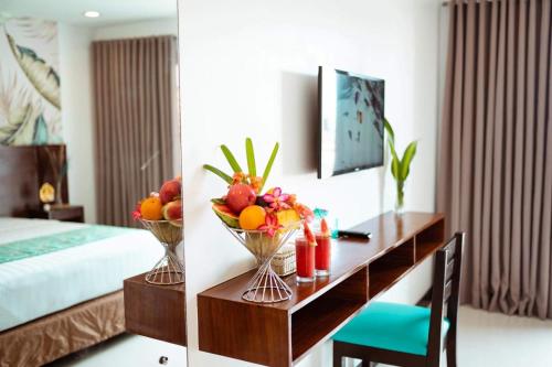 a hotel room with a desk with fruit on it at Jony's Boutique Hotel in Boracay