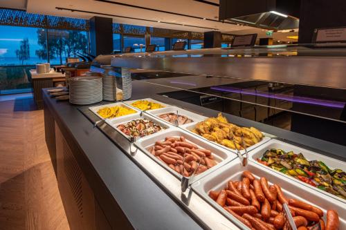 a buffet line with many different types of food at Hotel Helikon, Keszthely in Keszthely