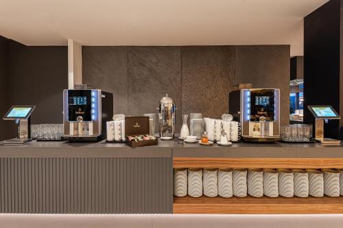 a counter with two coffee machines on it at Hotel Helikon, Keszthely in Keszthely