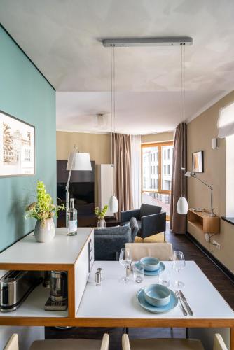 a living room with a table and a couch at The Green Rostock Apartment Hotel in Rostock