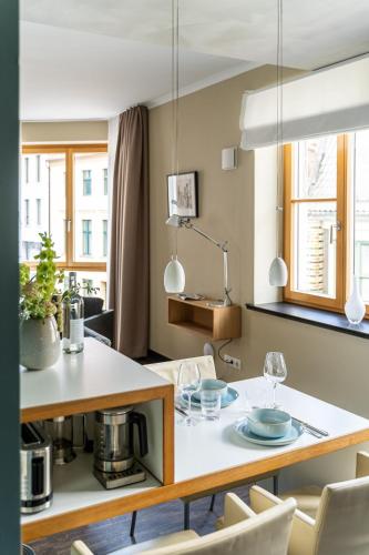a kitchen and dining room with a table and chairs at The Green Rostock Apartment Hotel in Rostock