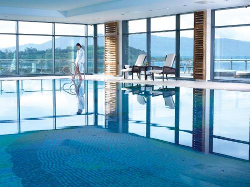 a man standing in the middle of a swimming pool at The Woodland Villas at Parknasilla Resort in Sneem