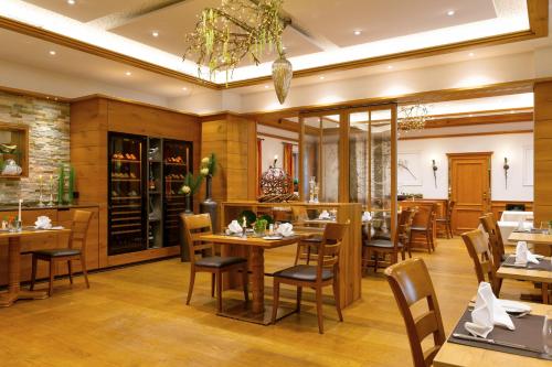 a dining room with wooden tables and chairs at Hotel-Restaurant Bierhäusle in Freiburg im Breisgau