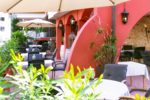 an outdoor restaurant with tables and chairs and umbrellas at Hotel-Restaurant Bierhäusle in Freiburg im Breisgau
