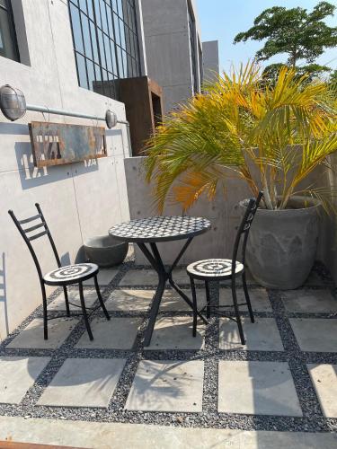 a patio with two chairs and a table and two chairs at The Cubes in Lusaka