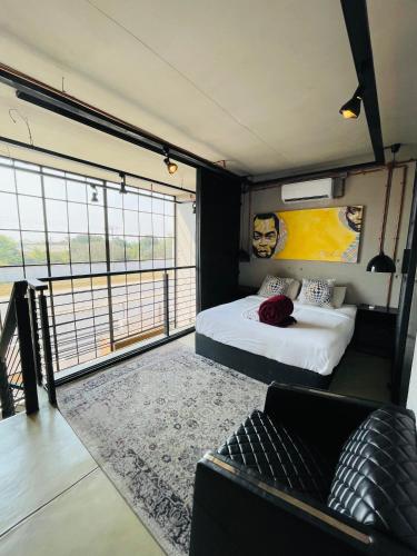 a room with two beds and a couch in it at The Cubes in Lusaka