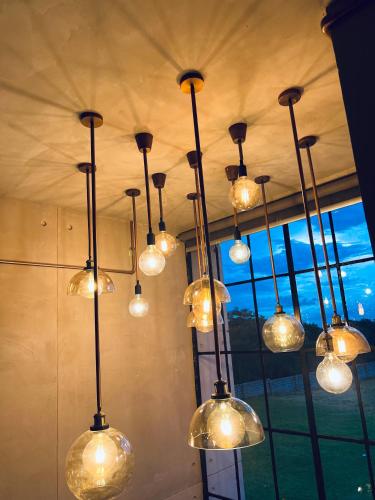 a bunch of lights hanging from a ceiling at The Cubes in Lusaka
