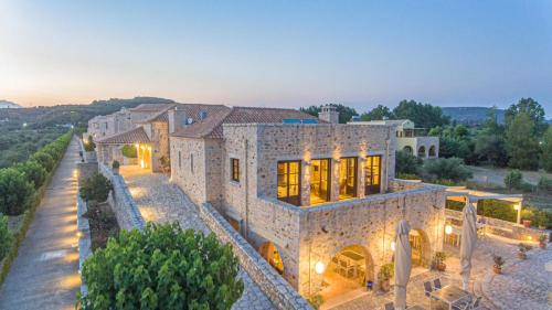 an aerial view of a stone house with trees at Castello Antico Hotel in Gythio