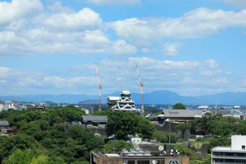 a view of a city with mountains in the background at KOKO HOTEL Premier Kumamoto in Kumamoto