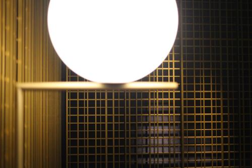 a mirror on top of a black tiled wall at KOKO HOTEL Premier Kumamoto in Kumamoto