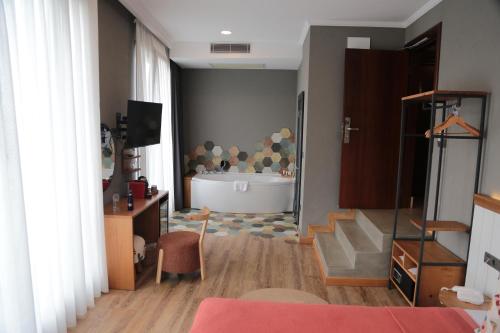 a living room with a bath tub and a bathroom at Istanbul Old City Colorful Houses Balat PETRION Hotel in Istanbul