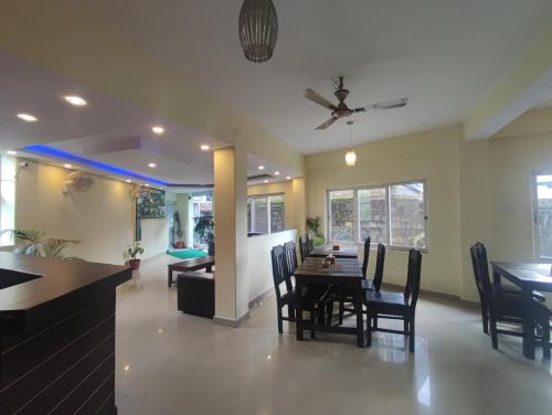 a dining room and living room with a table and chairs at Hotel My Dream in Pokhara