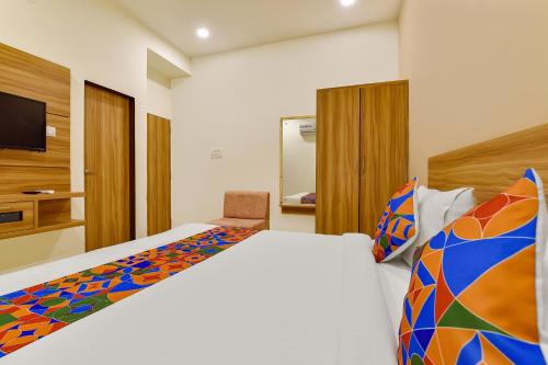 1 dormitorio con 1 cama grande y TV en FabHotel Prime Oxus, en Jaipur