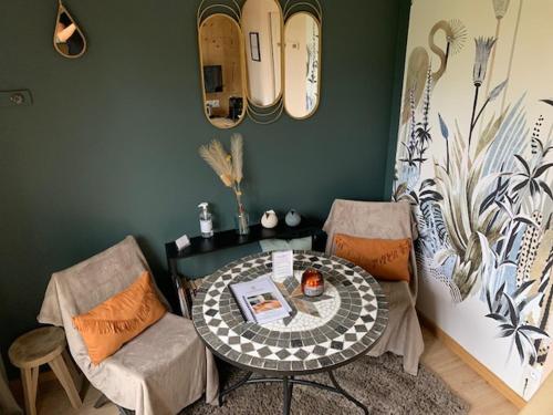 a dining room with a table and two chairs at La Casita in Pouilly-le-Monial