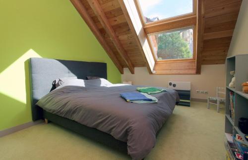 a bedroom with a large bed with a window at Chalet Sno Lodge in Les Deux Alpes
