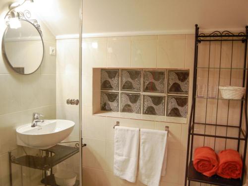 a bathroom with a shower and a sink and a mirror at Holiday Home Hofgasse-2 by Interhome in Mörbisch am See