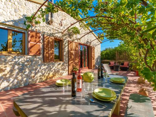 a table set for a meal on the patio of a house at Holiday Home Estrella by Interhome in Sant Llorenç des Cardassar