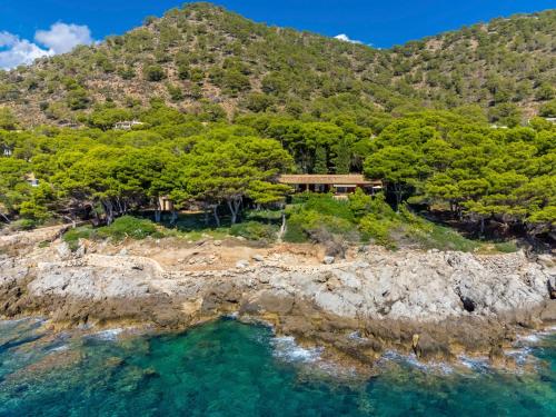 an aerial view of a house on a rocky island at Villa Finca L'Embat - DLP100 by Interhome in Son Servera