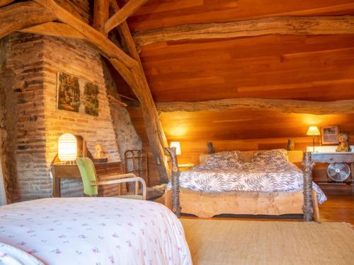 a bedroom with a bed in a room with wooden ceilings at Holiday Home Marguerite - BDD200 by Interhome in Chiddes