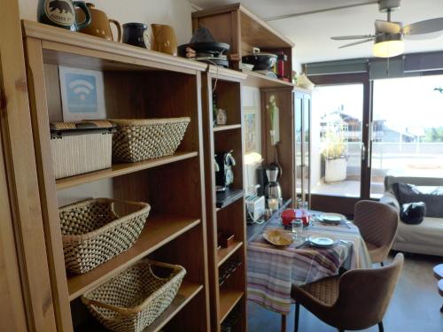 a room with a table and shelves with a dining room at Studio Jeanne D'Arc Apt- E-36 by Interhome in Crans-Montana