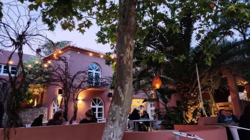 a restaurant with lights on the facade of a building at Salema Eco Camp - Sustainable Camping & Glamping in Salema