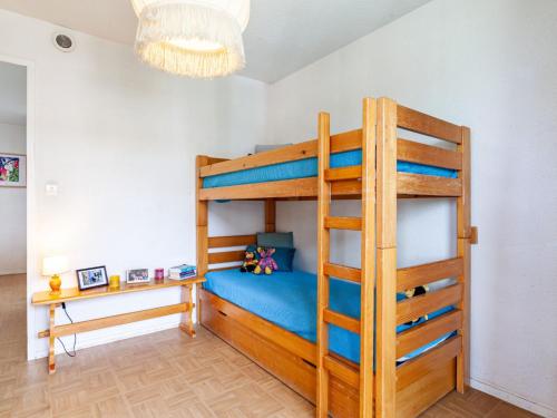 a bedroom with a bunk bed and a desk at Apartment Lunik Orion-18 by Interhome in Le Corbier