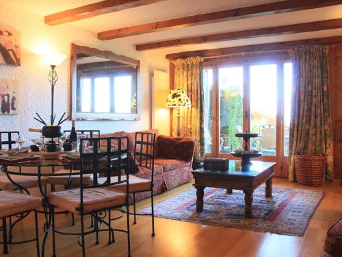 a living room with a table and a couch at Apartment Le Bouquetin 1 by Interhome in Villars-sur-Ollon