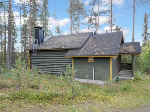 NissiにあるHoliday Home Metsämaja by Interhomeの森の中のポーチ付きログキャビン