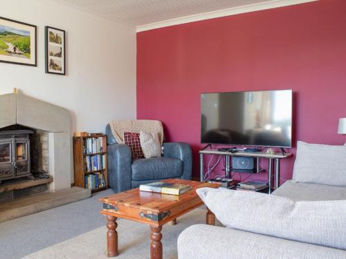 a living room with a couch and a tv at Holiday Home Viewfield by Interhome in Portree